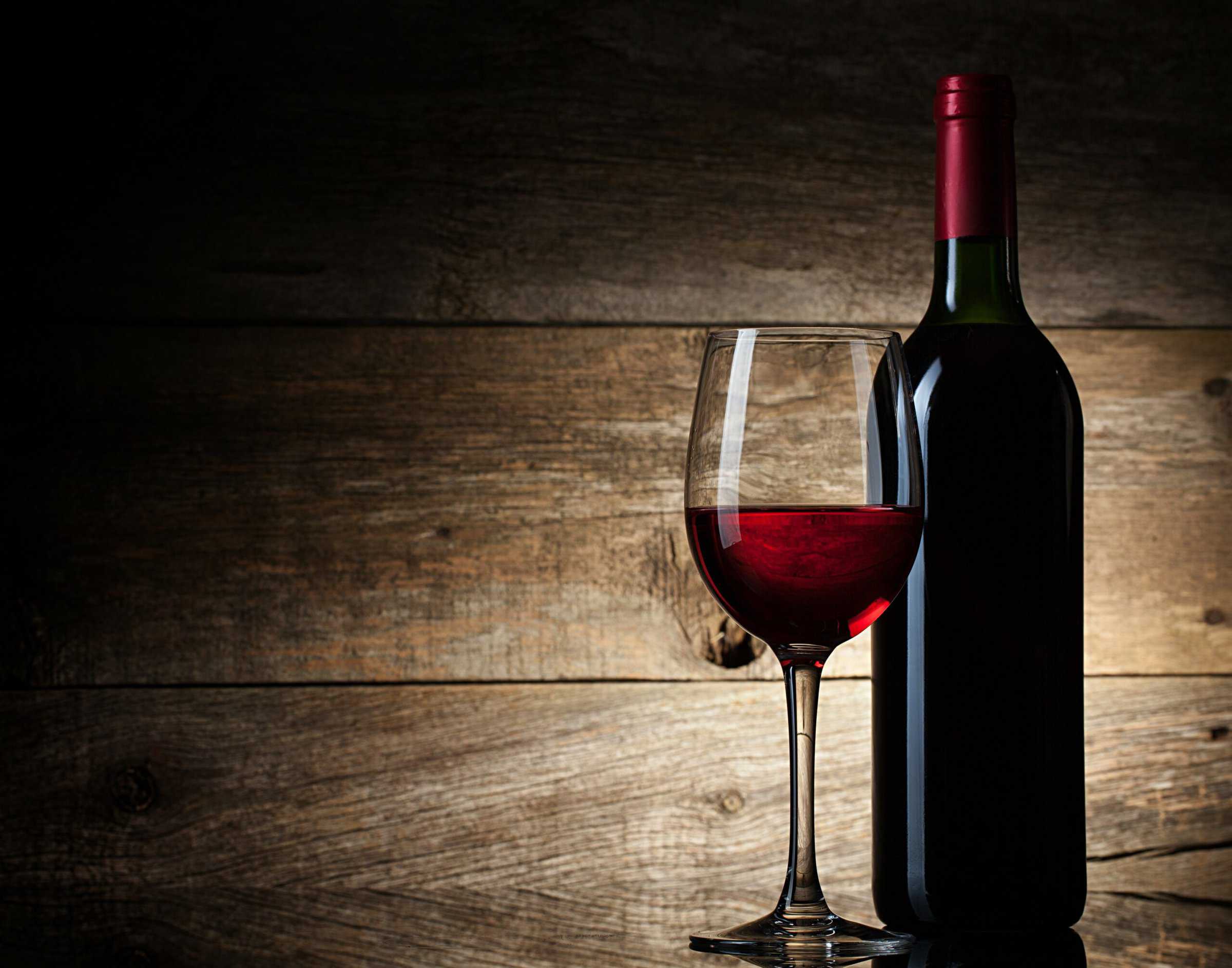 Wine glass and Bottle on a wooden background