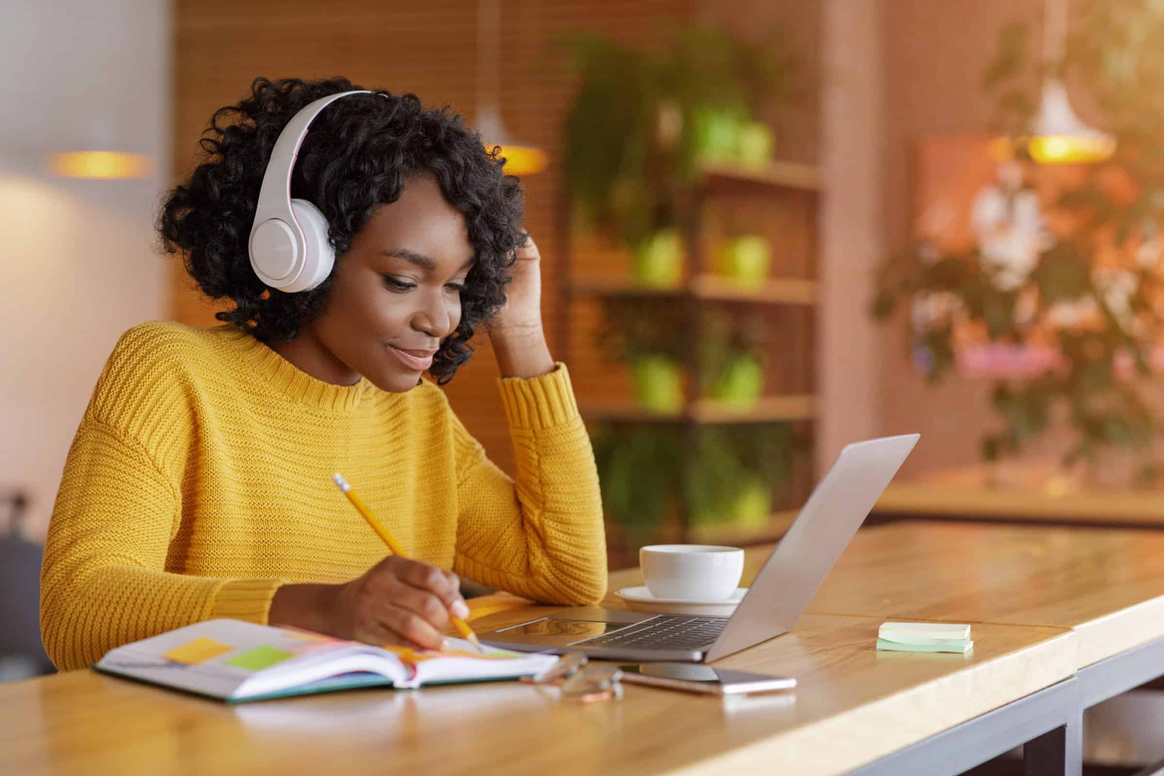 Smiling girl with headset studying online