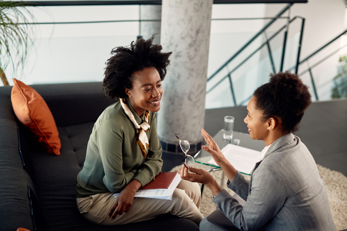 Stock image of two women speaking